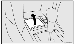 Mitsubishi Lancer: Front ashtray. To remove the ashtray, open the lid and lift upward holding the lid.