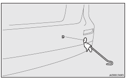 Mitsubishi Lancer: Emergency towing. 3. Use the wheel nut wrench (E) to firmly attach the towing hook (F).